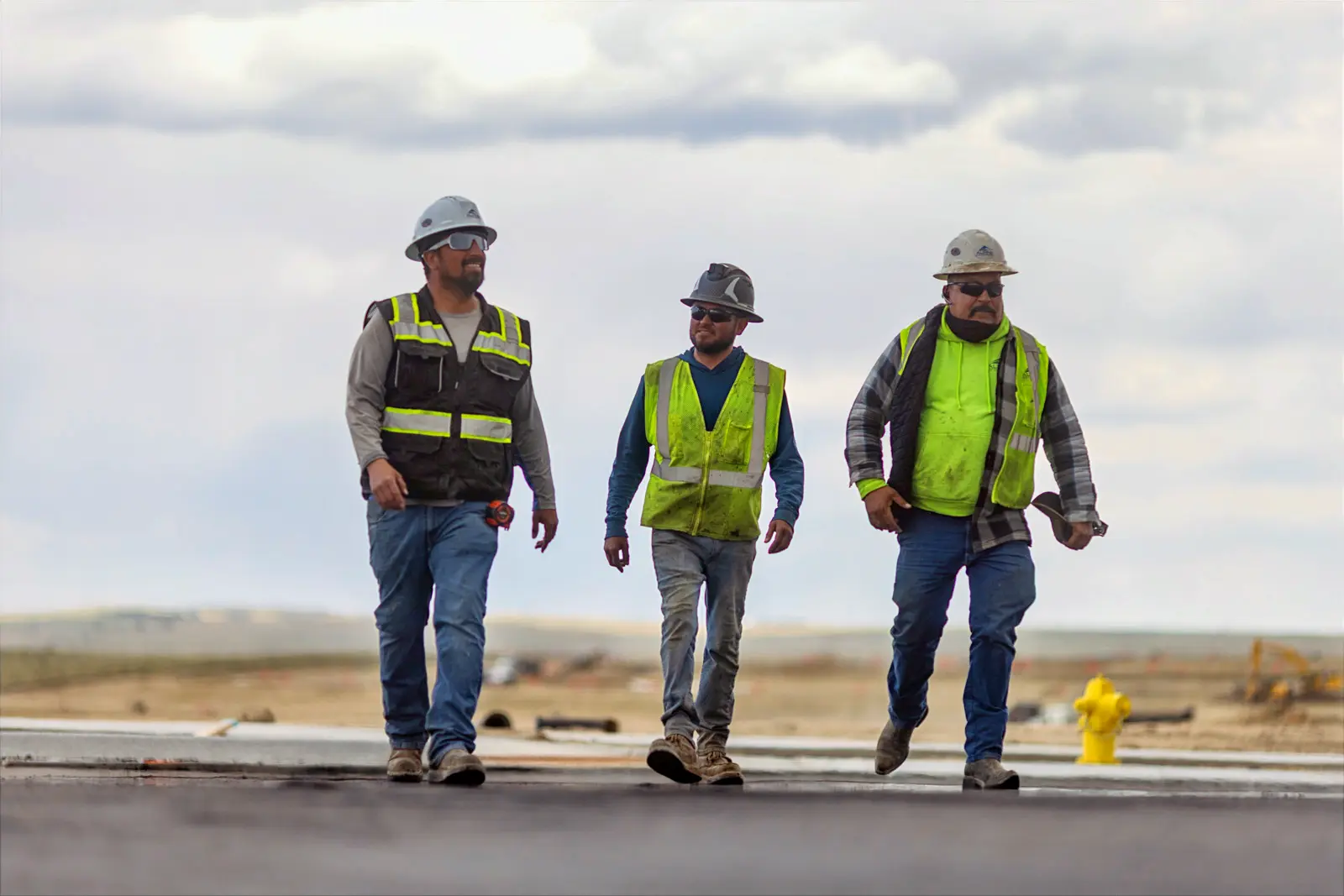 Three Alpine crew members on an asphalt job
