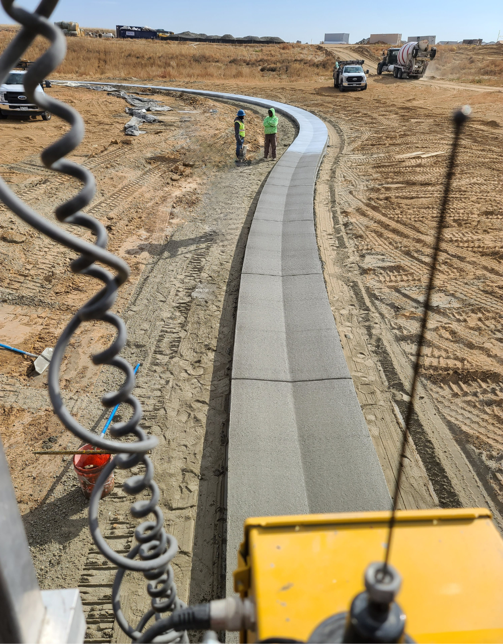 Curved concrete curb installation at construction site