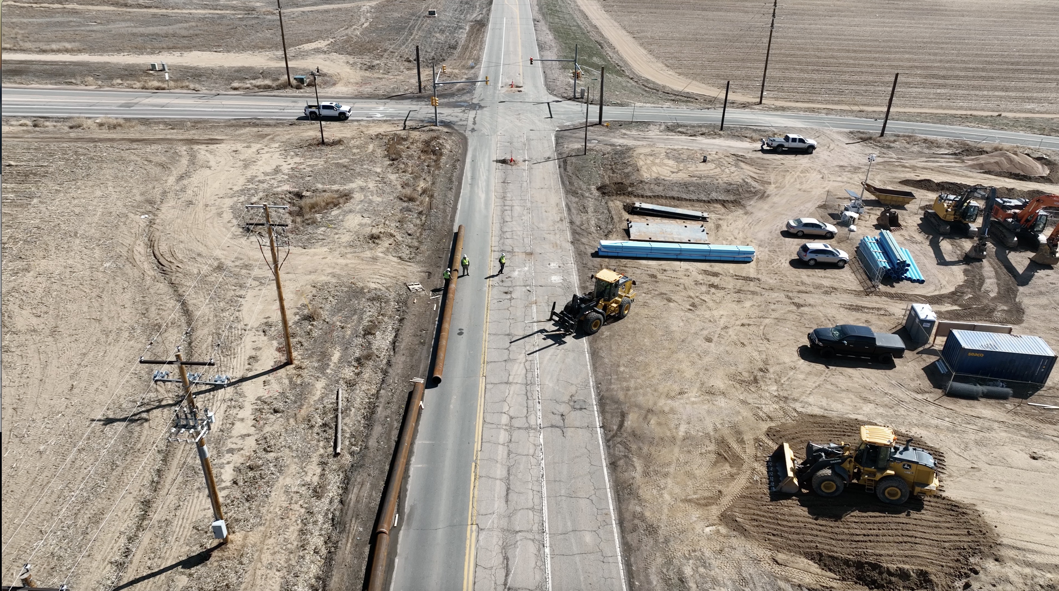 Aerial view of road construction with crews and heavy machinery