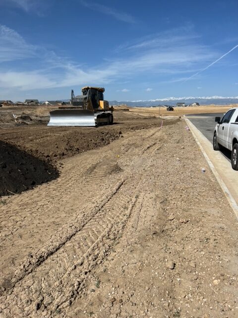 Concrete pouring operation with crew and excavator in residential area